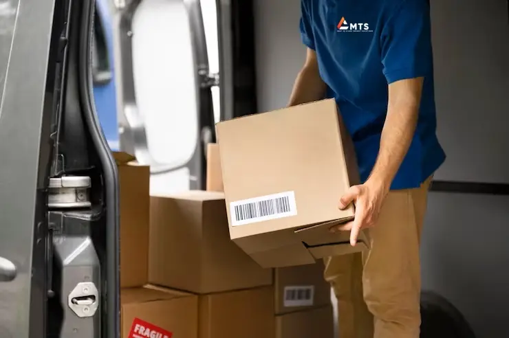 MTS-Courier driver loading next day courier collections into van,