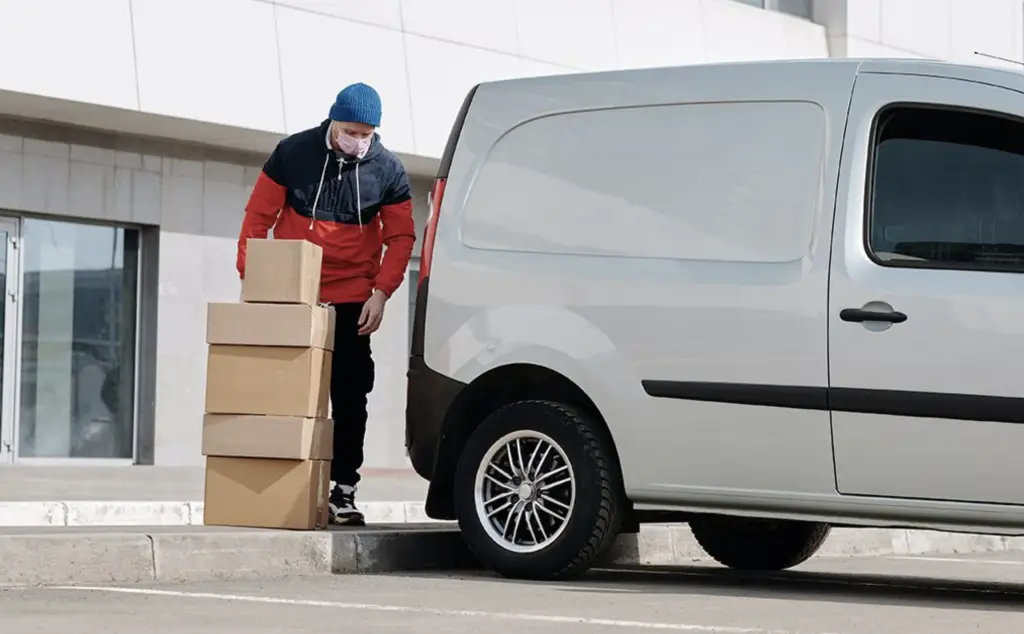 MTS-Courier driver loading up a collection of Next Day deliveries, collected form our client